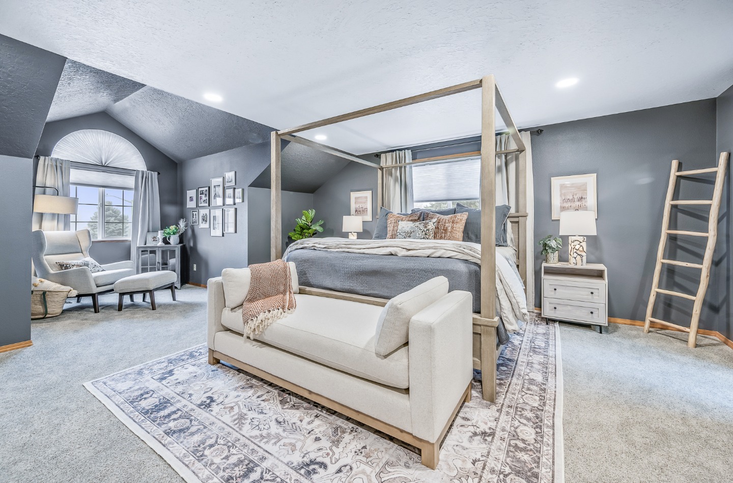 Primary bedroom with a canopy bed, styled by Interior Motives