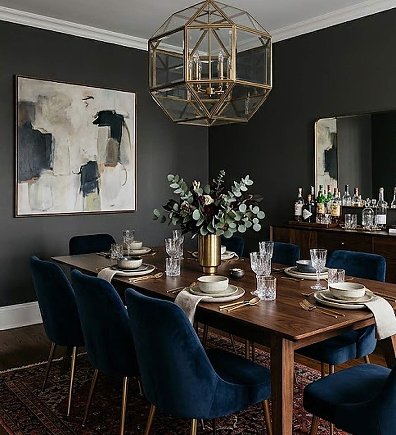 Moody charcoal dining room with a brass geometric pendant